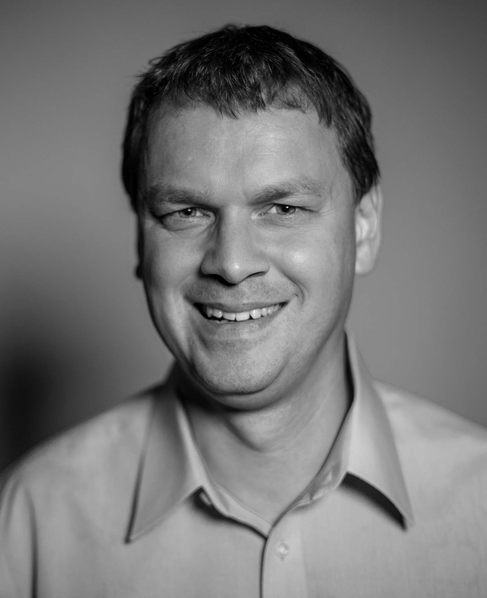 A Headshot Image of a Man in Black and White