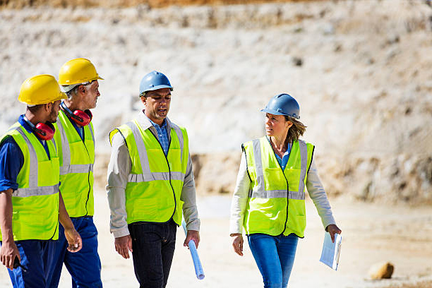 A Group of People in Overalls and Helmet